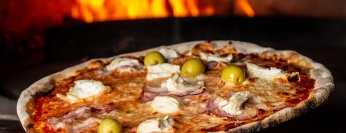Restaurant,Chef,Takes,Pizza,From,Oven.,Preparing,Traditional,Italian,Pizza.